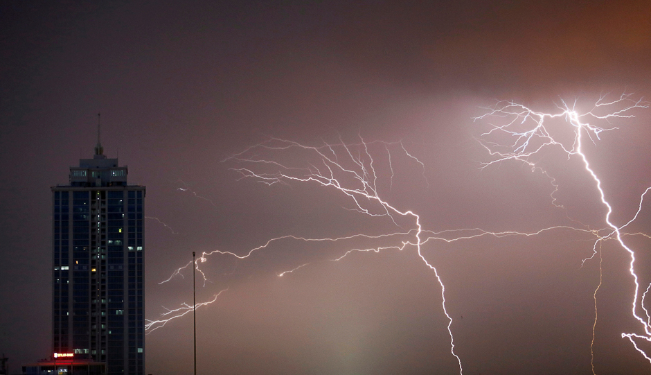 Lightning strikes behind commercial tower near a financial city in Colombo, Sri Lanka. PHOTO: REUTERS