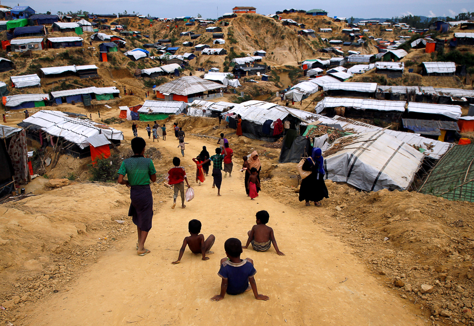 Rohingya refugee children slide down the road at Balu Khali refugee camp near Cox's Bazar, Bangladesh. PHOTO: REUTERS