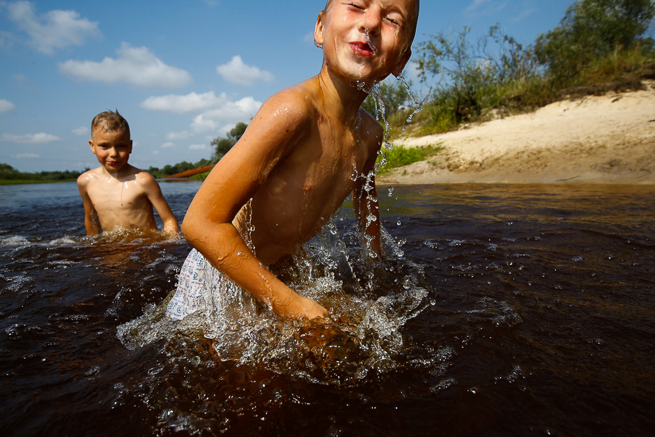 Boys play in the river of Stviga on a hot summer day near the village of Pogost, Belarus. PHOTO: REUTERS
