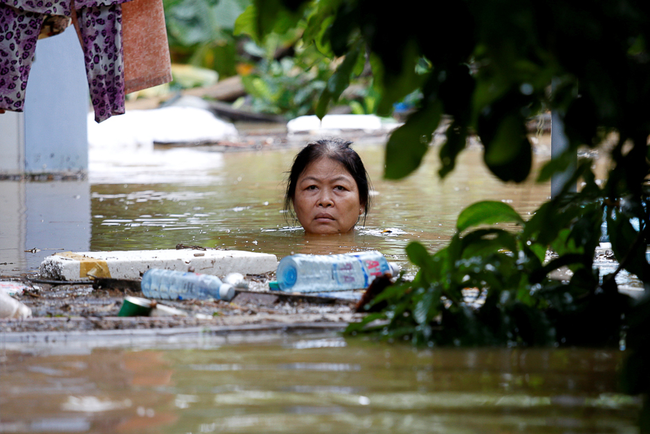 A woman wades through a submerged street at the UNESCO heritage ancient town of Hoi An after typhoon Damrey hits Vietnam. PHOTO: REUTERS