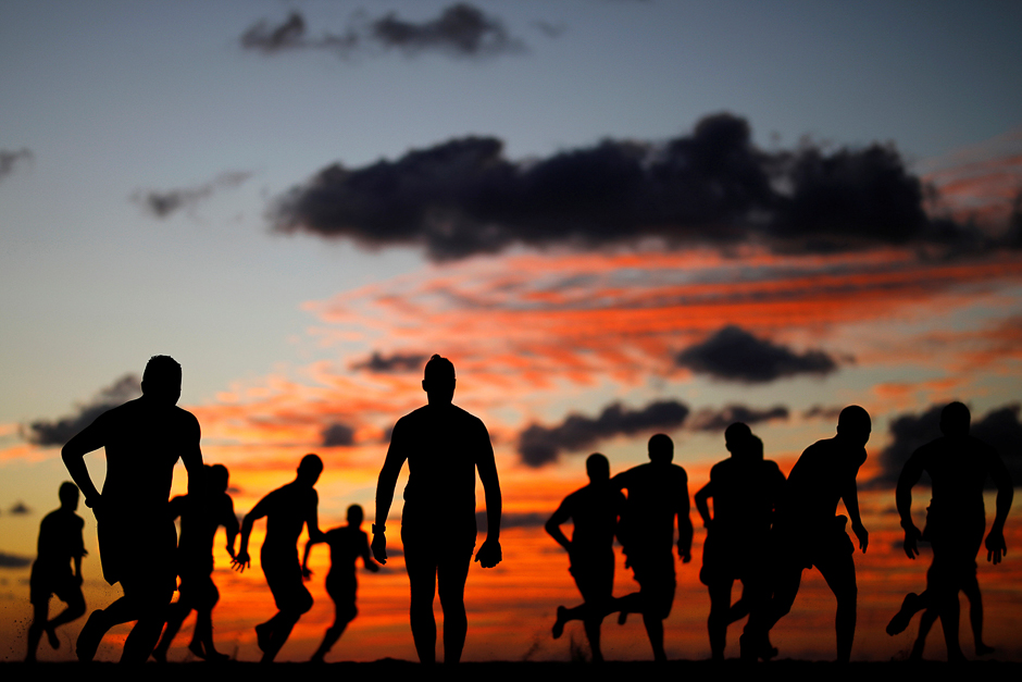 Youths train along the shore of the Mediterranean Sea in Ashkelon, Israel. PHOTO: REUTERS