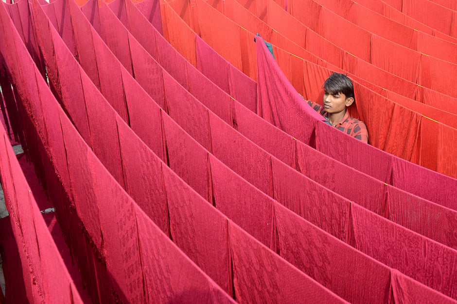 Indian artisan dries stoles after dyeing in Amritsar. PHOTO: AFP