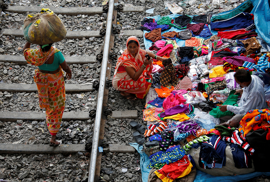 A woman shops beside a railway track in Kolkata, India. PHOTO: REUTERS