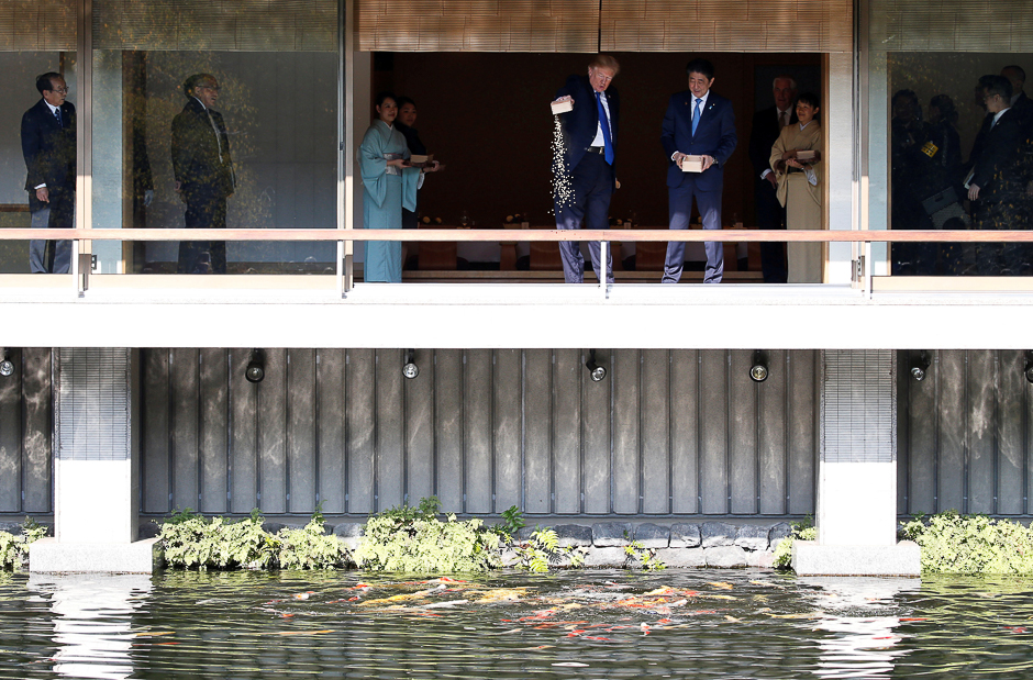 US President Donald Trump and Japan's Prime Minister Shinzo Abe feed carps before their working lunch at Akasaka Palace in Tokyo, Japan. PHOTO: REUTERS