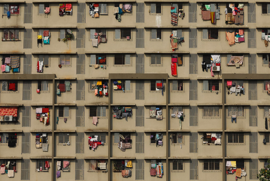 Washing hangs from the windows of a residential building, Mumbai, India. PHOTO: REUTERS