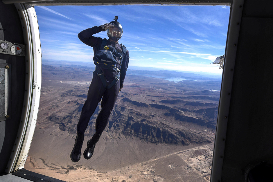 A member of the Air Force's Wings of Blue Parachute Demonstration Team salutes as he jumps out of an aircraft, during the opening ceremony of Aviation Nation 2017 Nellis Air and Space Expo at Nellis Air Force Base, Nev. PHOTO: REUTERS