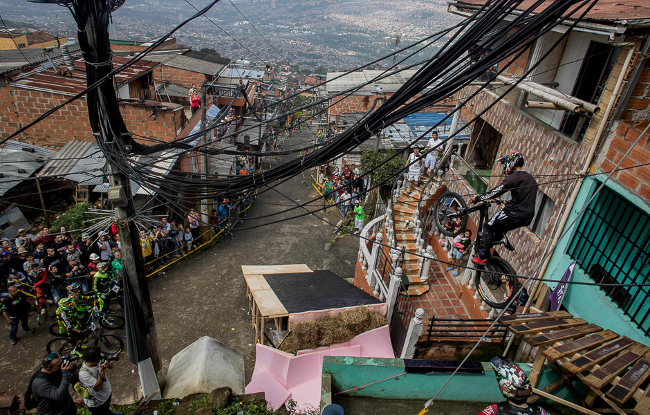 Residents watch as a downhill rider competes during the Urban Bike Inder Medellin race final at the Comuna 1 shantytown in Medellin, Antioquia department, Colombia. PHOTO: AFP