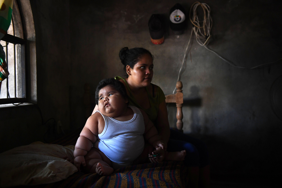 Ten-month-old Luis Gonzales (L) and his mother Isabel Pantoja, 24, are pictured at their home in Tecoman, Colima state, Mexico. PHOTO: AFP