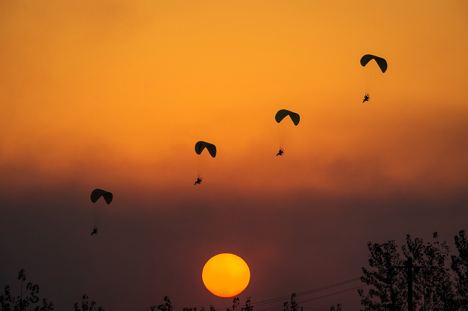 Powered parachutists practice for the upcoming 2017 FAI World Fly-in Expo at Hannan airport in Wuhan in China's central Hubei province. PHOTO: AFP