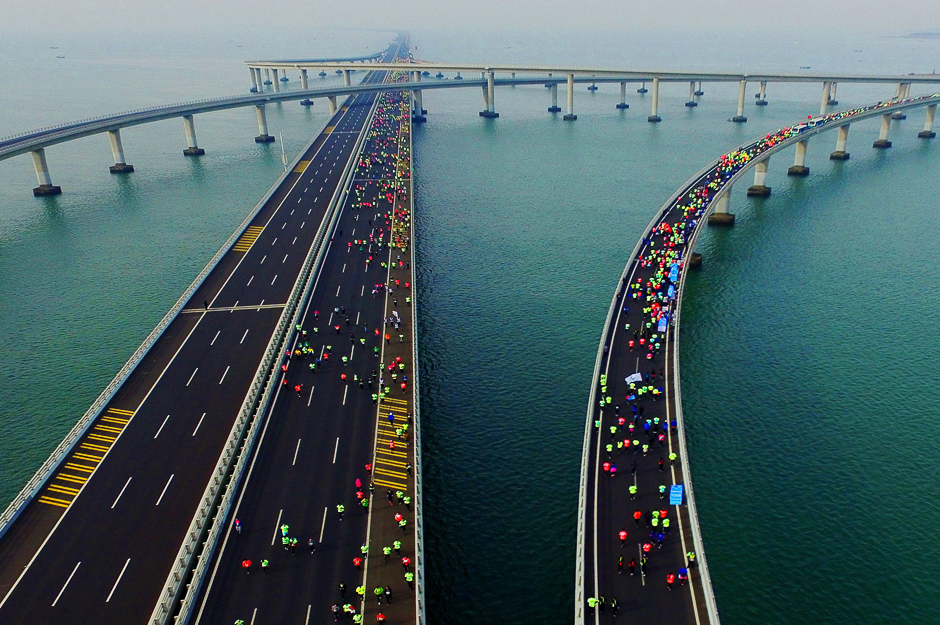 Participants crossing the Jiaozhou Bay Bridge as they compete in the 2017 Qingdao International Marathon on the Sea in Qingdao in China's eastern Shandong province. PHOTO: AFP