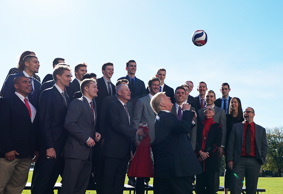 US President Donald Trump tosses a volleyball into the air while posing with members of the Ohio State Men's Volleyball team on the South Lawn of the White House during an event honoring NCAA national championship teams in Washington, DC. PHOTO: AFP