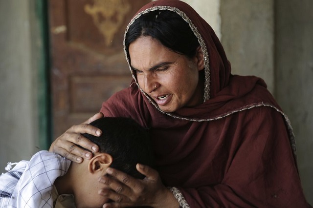 In this picture taken on May 4, 2017, Kausar Parveen comforts her child who was allegedly raped by a mullah or religious cleric, in Kehror Pakka, Pakistan. PHOTO: AP