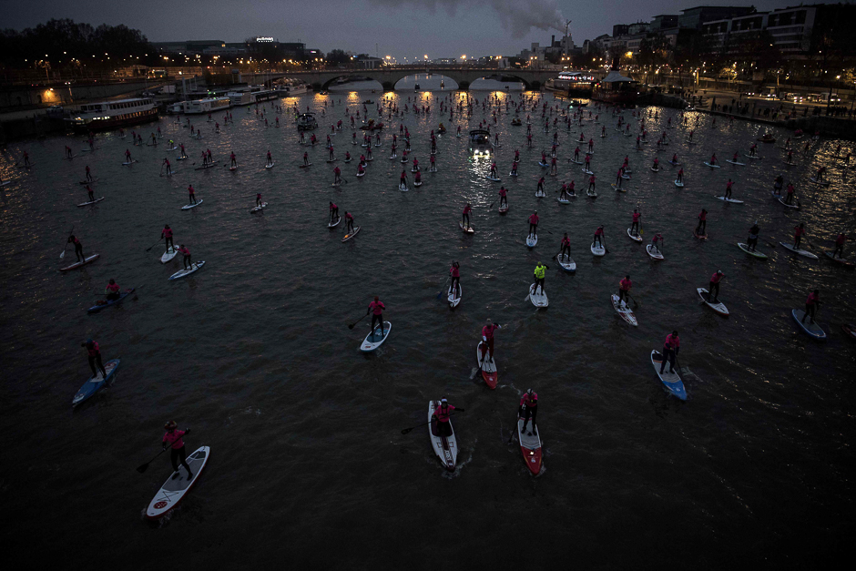 Amateurs and professionals take the start in the Nautic Sup Paris crossing stand up paddle race along the Seine River in Paris. PHOTO: AFP