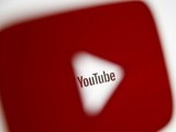 a-3d-printed-youtube-icon-is-seen-in-front-of-a-displayed-youtube-logo-in-this-illustration-2