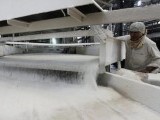 a-worker-checks-the-flow-of-sugar-inside-the-gandavi-sugar-factory-165-km-102-miles-south-of-the-western-indian-city-of-ahmedabad-3-2-2