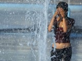 a-girl-cools-off-in-the-unisphere-fountain-at-the-flushing-meadows-corona-park-in-the-queens-borough-of-new-york
