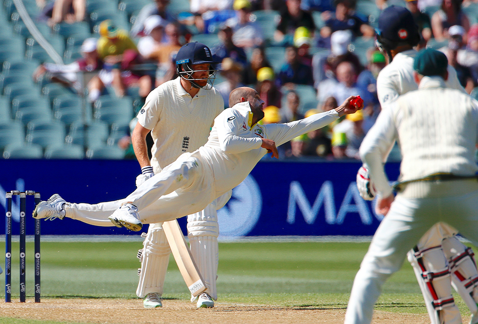 Cricket - Ashes test match - Australia v England - Adelaide Oval, Adelaide, Australia. Australia's Nathan Lyon dives to take a catch to dismiss England's Moeen Ali during the third day of the second Ashes cricket test match. PHOTO: REUTERS