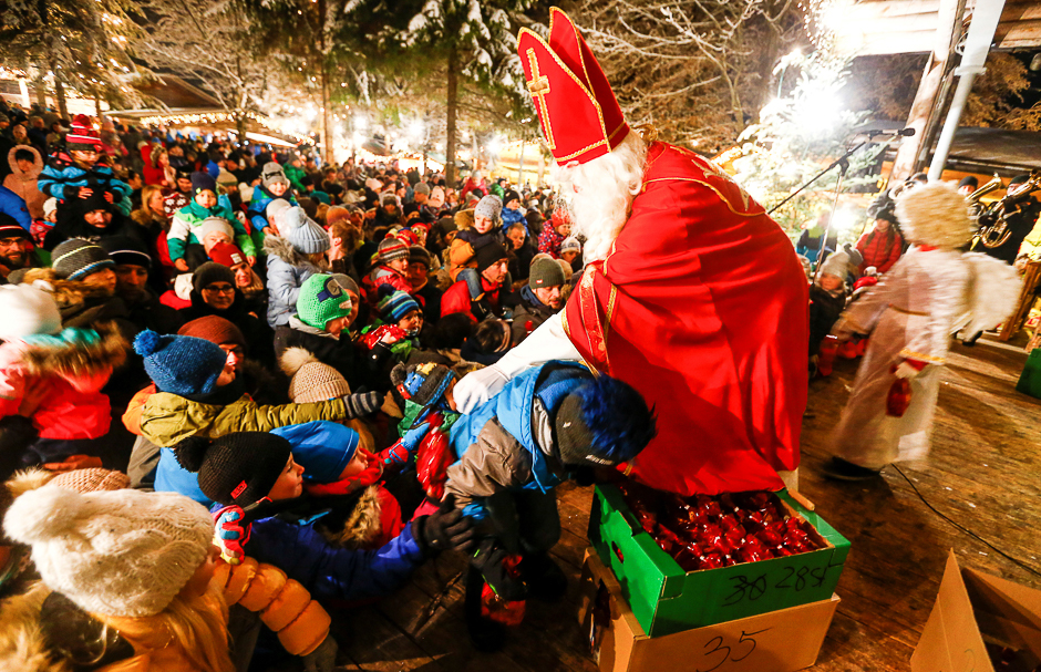 A man dressed as Santa Claus gives sweets to children in Mayrhofen. PHOTO: REUTERS