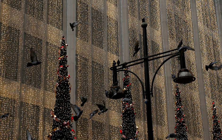 Pigeons fly in front of the Christmas lights on the facade of House of Fraser department store on Oxford Street in London, Britain. PHOTO: REUTERS