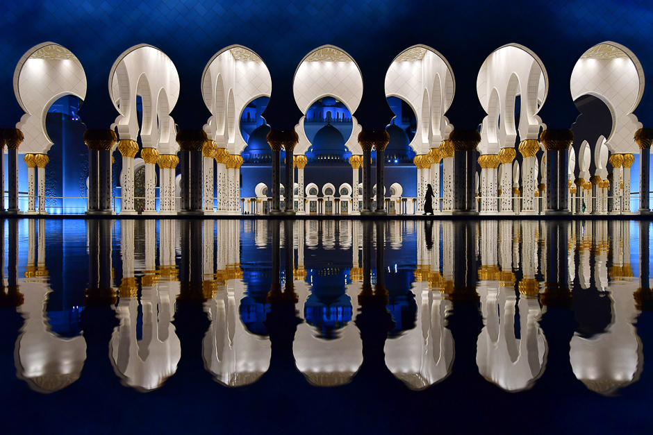 Visitors walk in the courtyard of the Sheikh Zayed Grand Mosque in the UAE capital Abu Dhabi. PHOTO: AFP