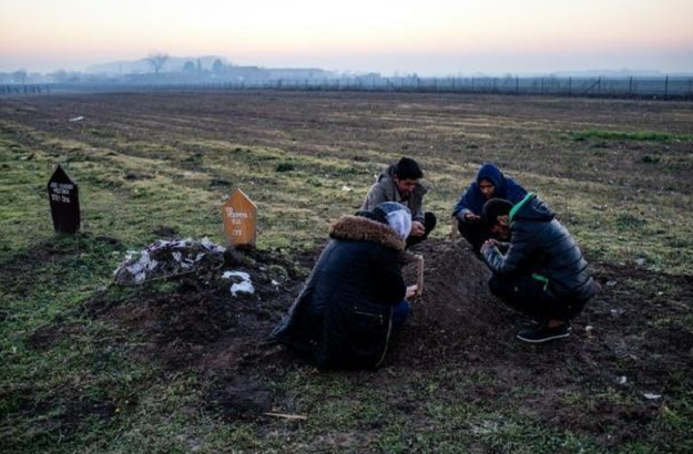Hussein family members gather around the grave of six year-old Madina in the Serbian town of Sid. PHOTO: AFP