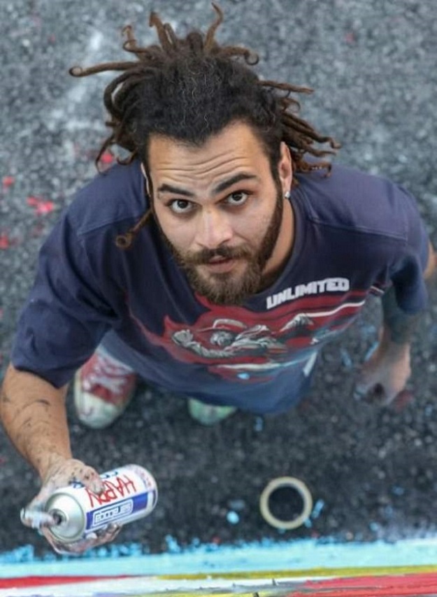 Suhaib Attar, a 25-year-old graffiti artist, paints a mural in the Jordanian capital Amman. PHOTO: AFP