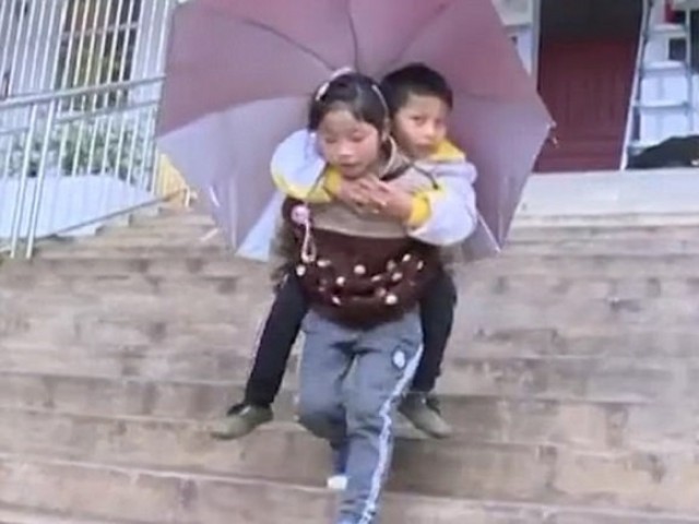 Image result for Nine-year-old girl carries brother to school every day