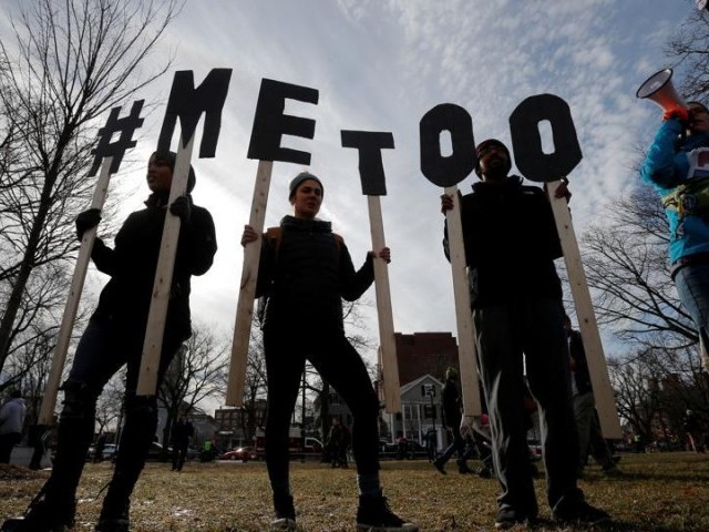 Demonstrators spell out â#METOOâ during a women's march in Cambridge, Massachusetts. PHOTO: REUTERS