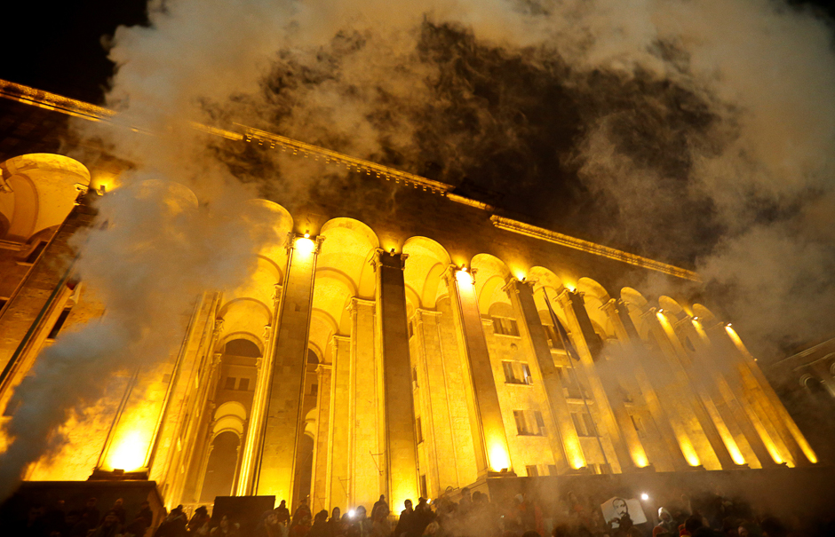 Protestors use smoke flares during a rally against government's drug policy in front of the Parliament building in Tbilisi, Georgia. PHOTO: REUTERS