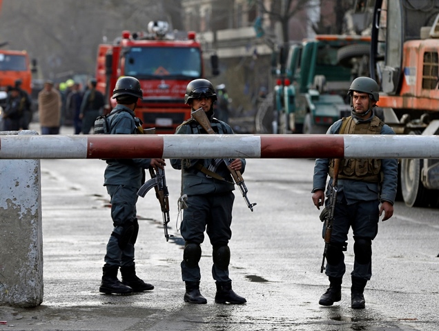 Afghan police keep watch at the site of a car bomb attack in Kabul, Afghanistan January 27, 2018. PHOTO: REUTERS