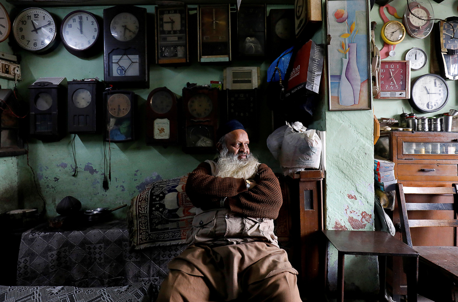 A man sits inside his 42-year old shop of antique clocks in the old quarters of Delhi, India. PHOTO: REUTERS