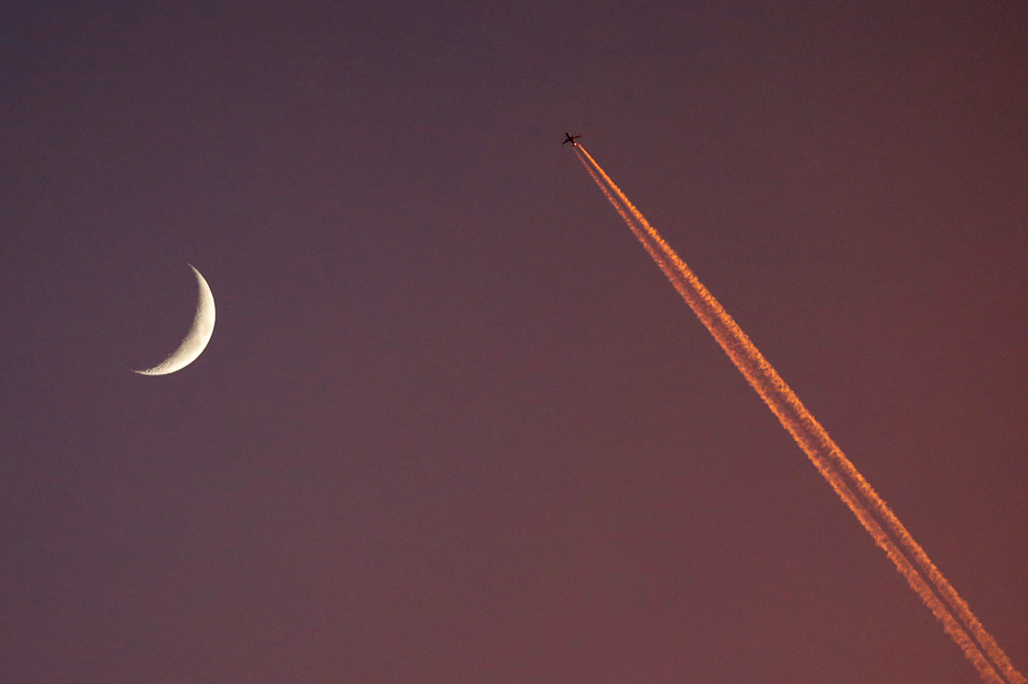 General view of the moon as a plane flies past in Monaco. PHOTO: REUTERS
