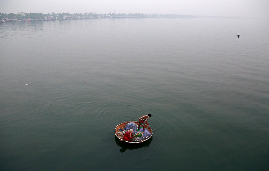 A fisherman and his wife catch fish in the waters of Vembanad Lake in Kochi, India. PHOTO: REUTERS