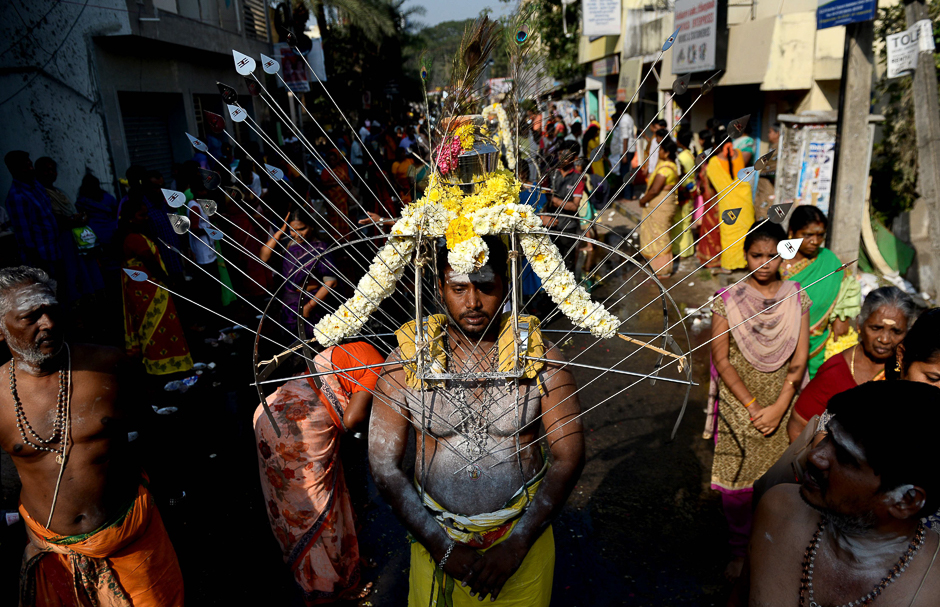 A Hindu devotee with his body pierced with metal skewers takes part in procession during the Thaipoosam festival in Chennai. PHOTO: AFP