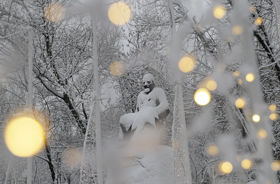 A view shows a monument to Kazakh poet Abai Kunanbayev after a heavy snowfall, with illumination lights seen in the foreground, in Moscow, Russia. PHOTO: REUTERS