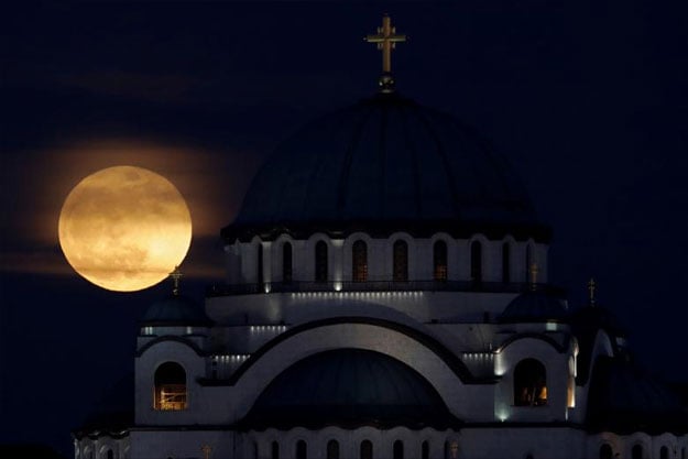 A full moon rises behind St. Sava temple in Belgrade, Serbia. PHOTO: REUTERS/Marko Djurica
