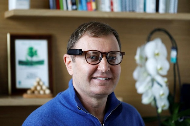 Ziv Aviram, CEO and co-founder of OrCam, poses for a portrait wearing the OrCam MyEye 2.0 device attached to a pair of glasses in his office in Jerusalem, February 15, 2018. PHOTO: REUTERS