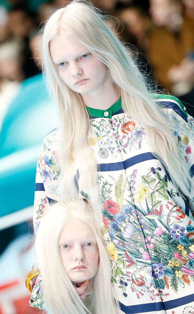 A Gucci model holds a replica of his own head on the runway. PHOTO: THE SUN