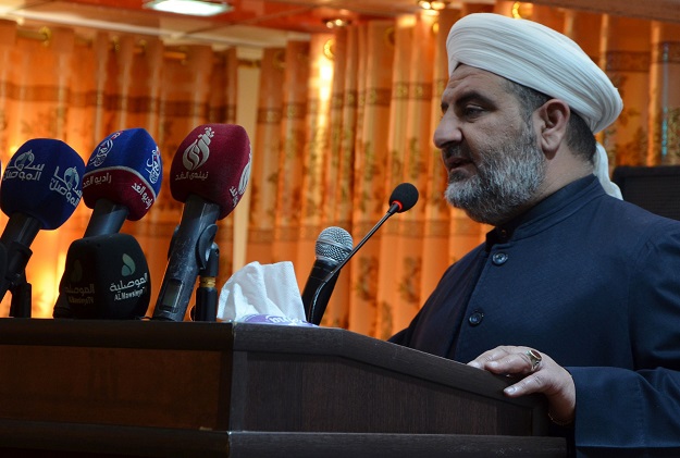 Sheikh Saleh al-Obeidi, head of the Muslim Scholars Forum of Mosul, delivers a speech at a graduation ceremony in the northern Iraqi city on February 8, 2018. Iraqi volunteers aged from 25 to 45 heralding from all sectors of society in Mosul PHOTO:AFP