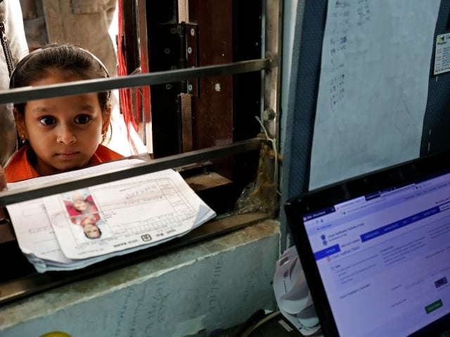 A girl waits for her turn to enrol for the Unique Identification (UID) database system, also known as Aadhaar, at a registration centre in New Delhi. PHOTO: Reuters
