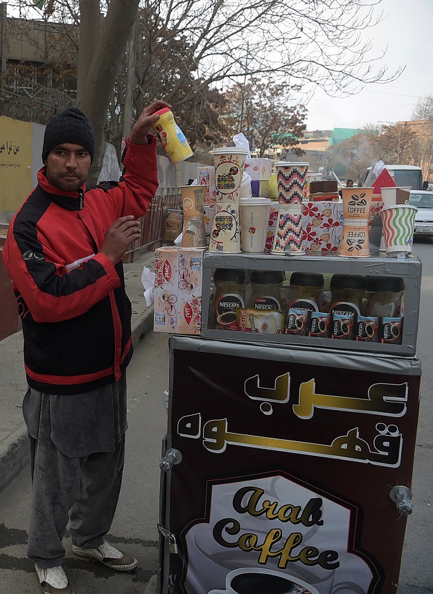 File photo of Najibullah Sharyari waiting for customers at his coffee cart in Kabul, January 8, 2018. PHOTO: AFP/ File