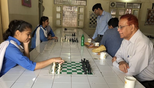 Chess player Bushra Maqsood with her coach and former grandmaster Shahzad Mirza at SMB Fatima Jinnah Government Girls School, in Karachi, Pakistan. Picture taken February 24, 2017. PHOTO: Thomson Reuters Foundation