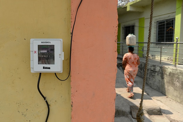 This photo taken on March 9, 2018 shows a woman walking through an alley in a village on Elephanta Island near Mumbai. Hundreds of villagers on the UNESCO heritage-listed island of Elephanta have had mains electricity installed in their houses for the first time. Local officials hope tourists, who take a short boat ride from the bustle of Mumbai to visit the island's famed fifth century caves, will now spend more time and money there, boosting local businesses and jobs. PHOTO: AFP