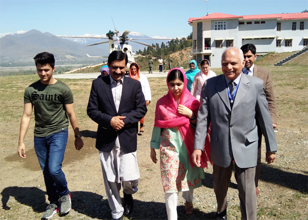 Malala Yousafzai arrives along with her father Ziauddin Yousafzai (2L), brother Atal Yousafzai (L) and the principal of all-boys Swat Cadet College Guli Bagh, during her hometown visit, some 15 kilometres outside of Mingora, on March 31, 2018. PHOTO: AFP 