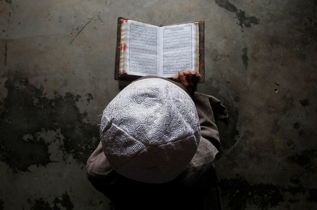  A Muslim boy learns to read the Koran at a madrassa, or religious school, during the holy month of Ramadan, on the outskirts of Agartala. There are 172 million Muslims in India. PHOTO: REUTERS