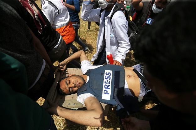  Mortally wounded Palestinian journalist Yasser Murtaja, 31, is evacuated after getting shot by IDF sniper in the southern Gaza Strip. PHOTO: REUTERS 
