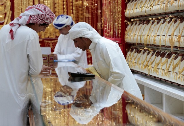 men look at gold jewellery in a shop at the gold souq in dubai united arab emirates march 24 2018 picture taken march 24 2018 photo reuters