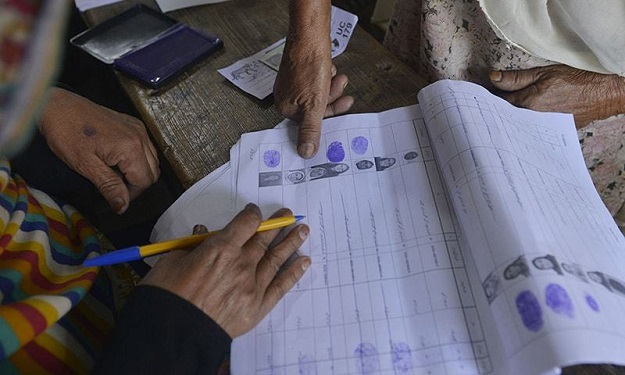 A Pakistani voter registers her vote during a local government election at a polling station in Lahore. PHOTO: AFP