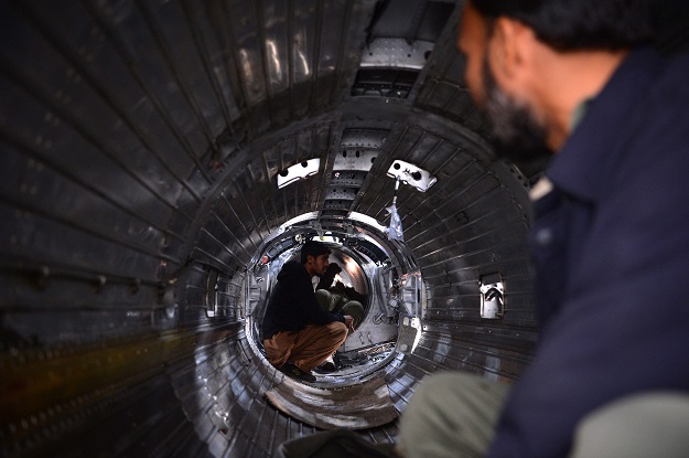 In this picture taken on December 27, 2017, technicians work on a Mirage aircraft during a full overhaul by the Pakistan Air Force (PAF) at the Mirage Rebuild Factory (MRF) in Kamra, west of the capital Islamabad. PHOTO: AFP