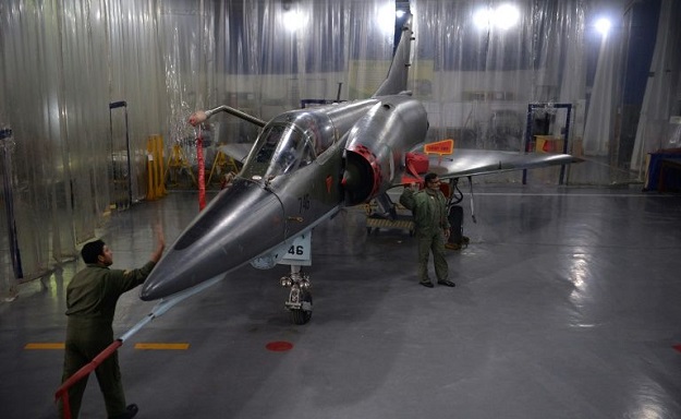 In this picture taken on December 27, 2017, technicians inspect a Mirage aircraft after the installation of air-to-air refueling probe as it undergoes an overhaul by the Pakistan Air Force (PAF) at the Mirage Rebuild Factory (MRF) in Kamra, west of the capital Islamabad. PHOTO: AFP